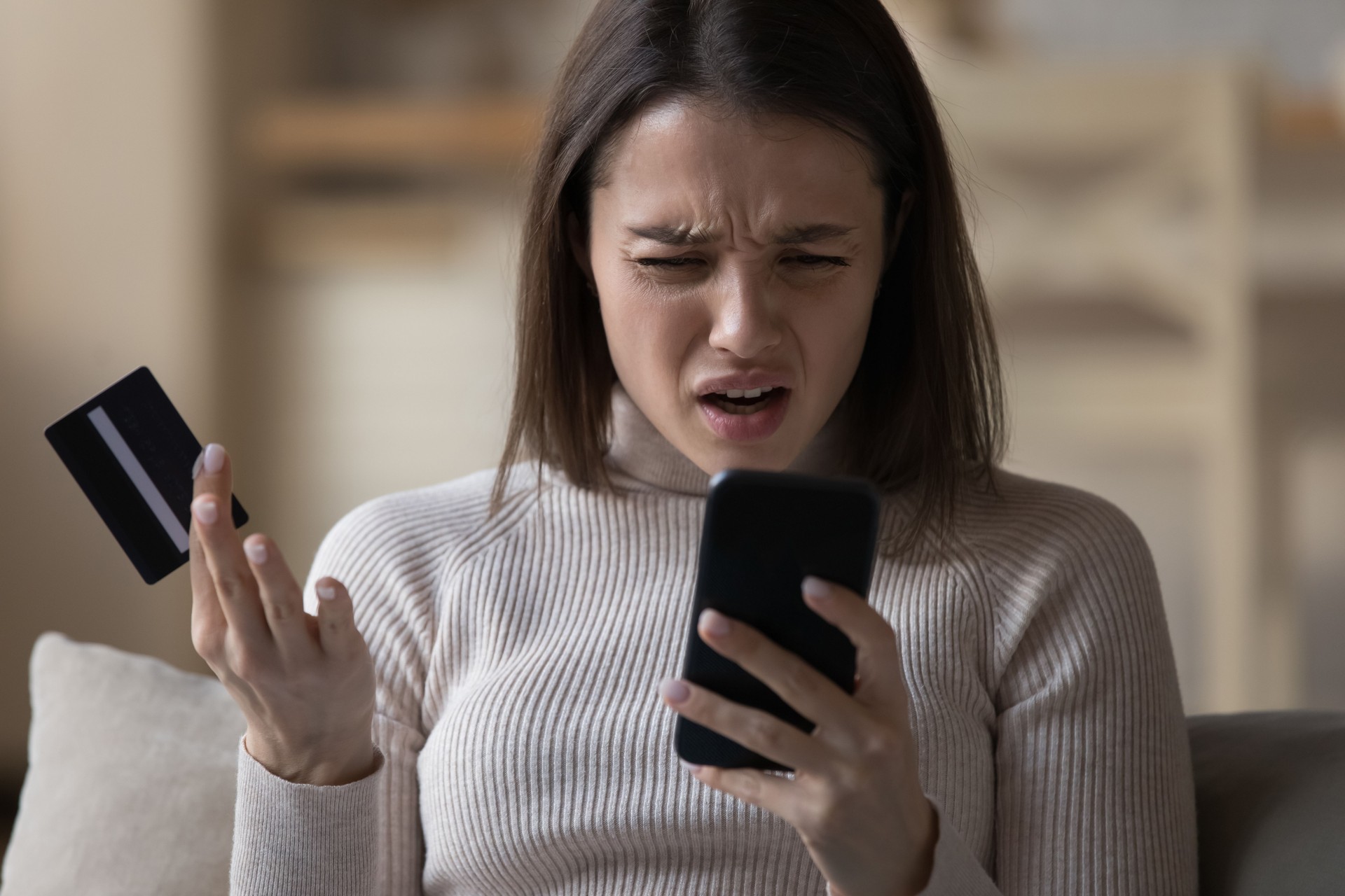 Woman experiences problems while pay bills use cellphone and card